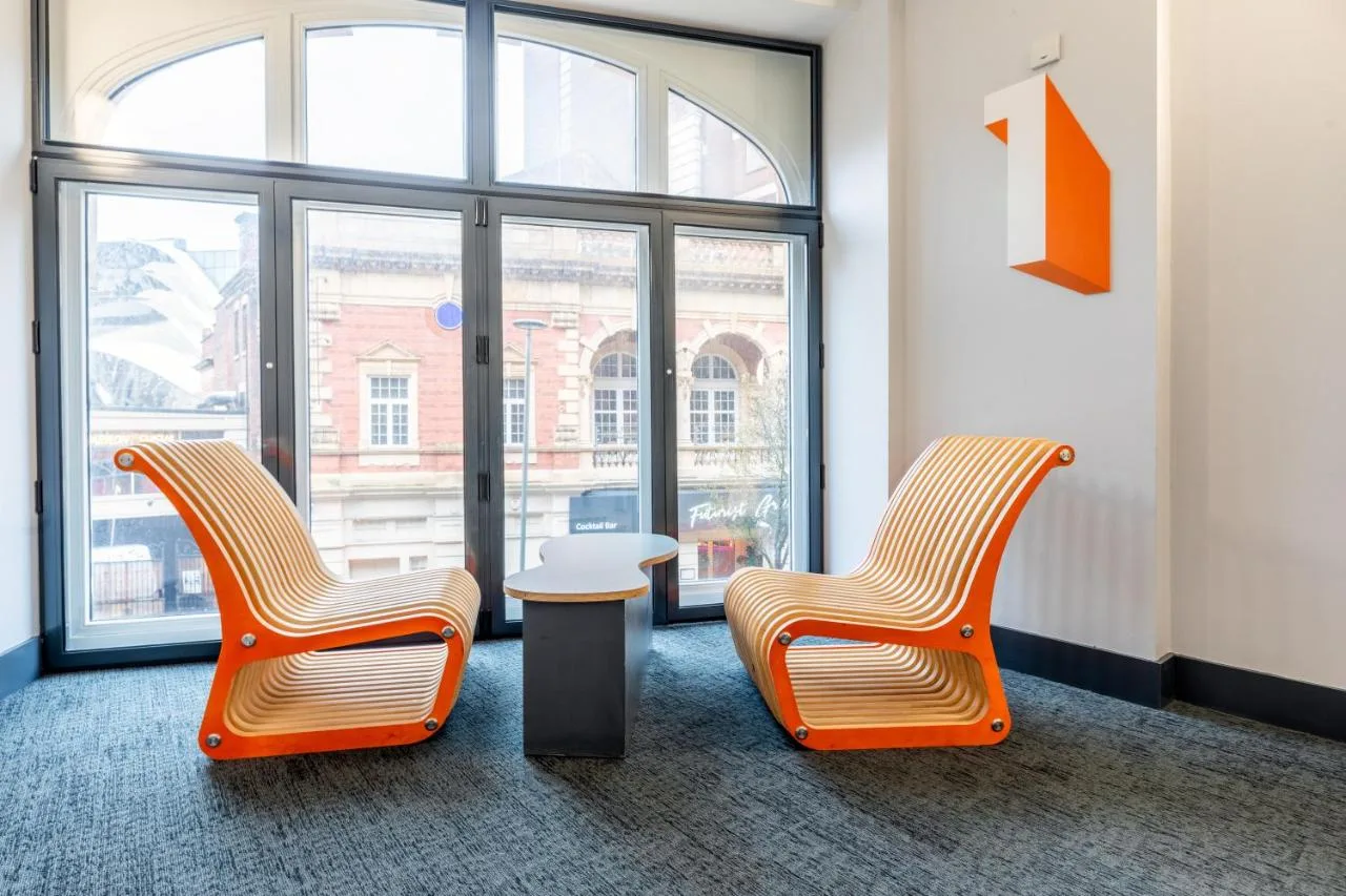 Two chairs and a table by a window at easyHotel Birmingham