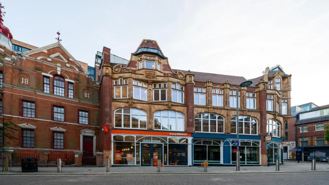 Large brick building on a Birmingham city street at easyHotel Birmingham