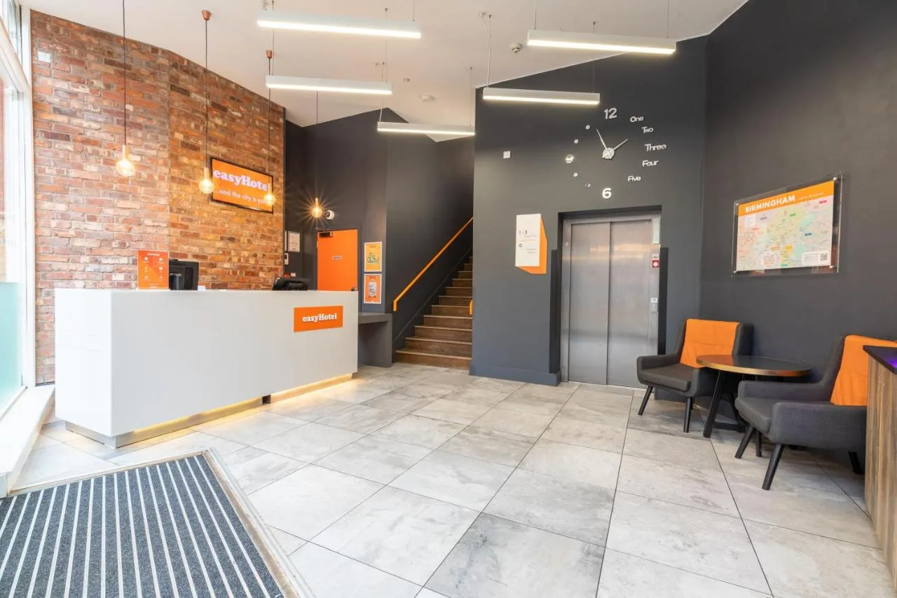 Office-style lobby with staircase, table and chairs at easyHotel Birmingham